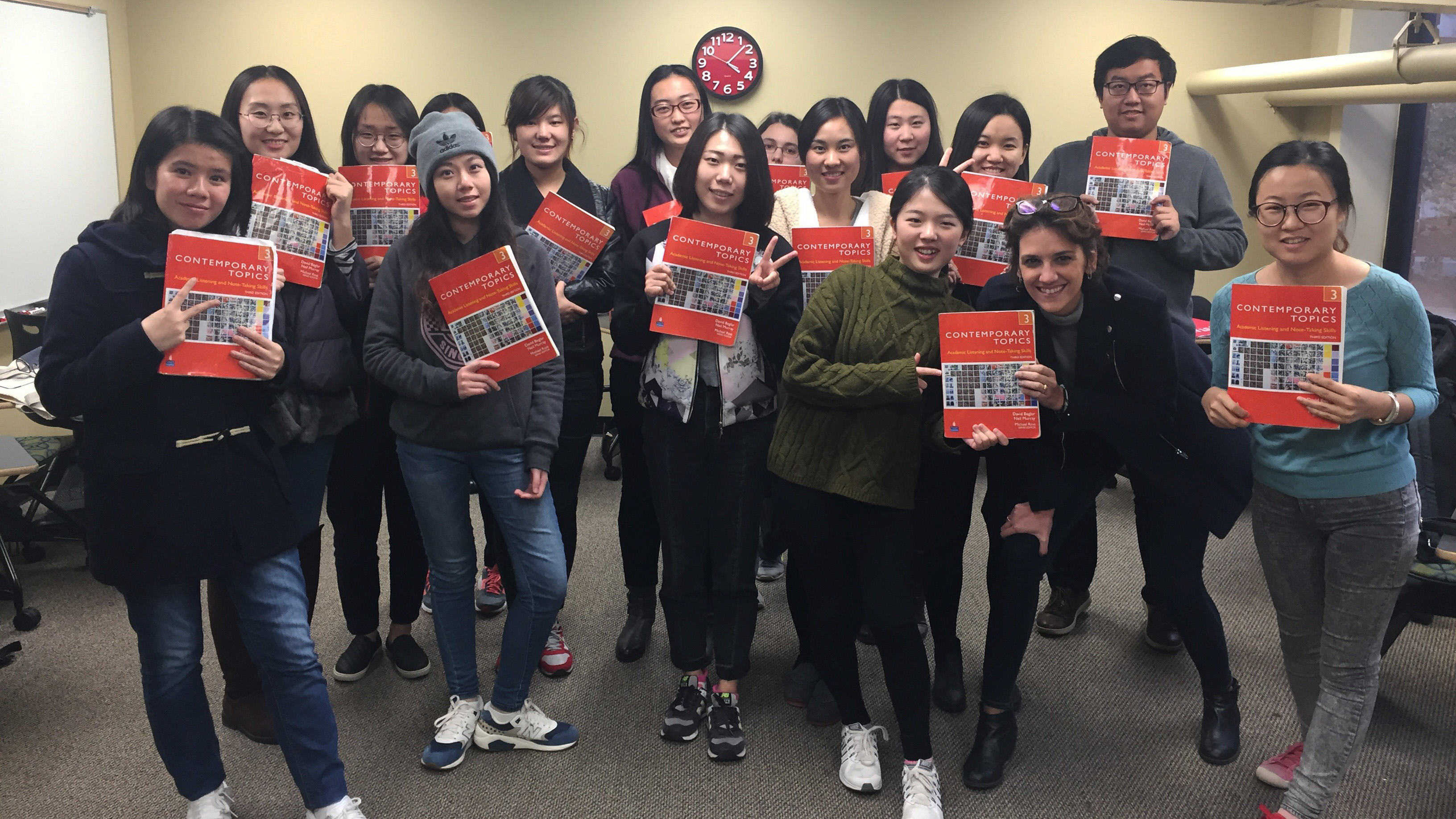 PMP students holding up their textbook.
