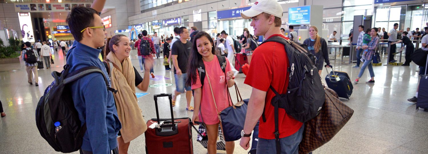 NC State students with luggage at RDU International Airport.