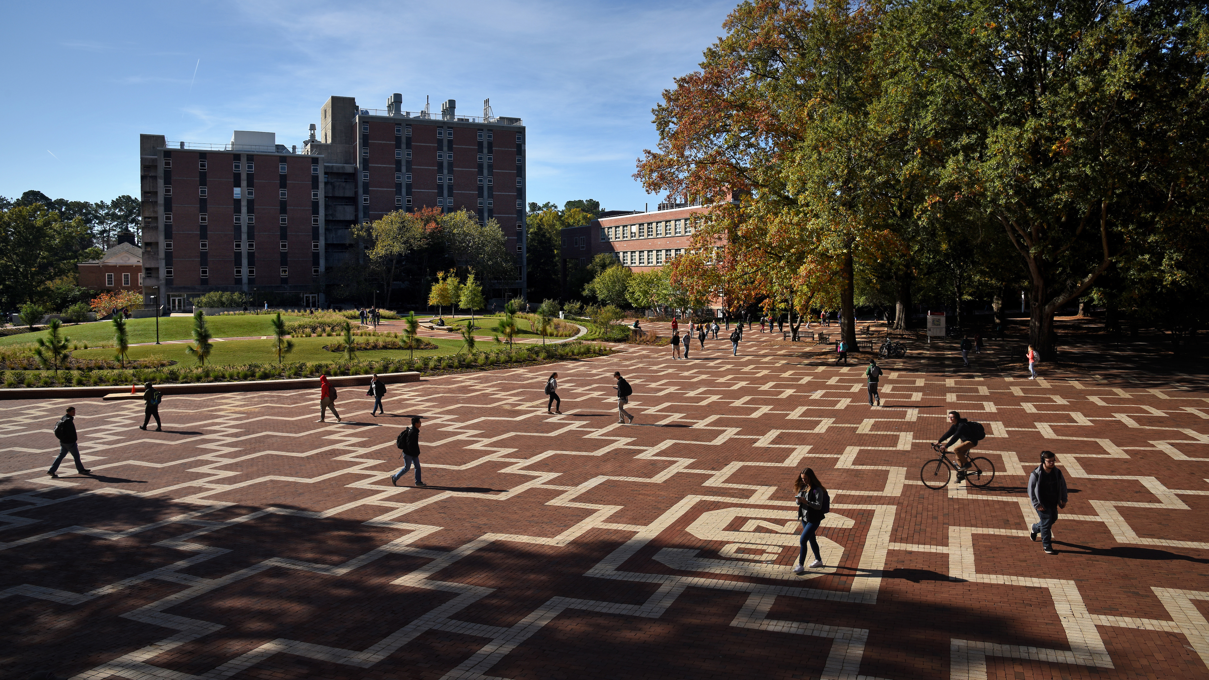 Students walk to class on North Campus at the Brickyard, near the space where Harrelson Hall used to be.